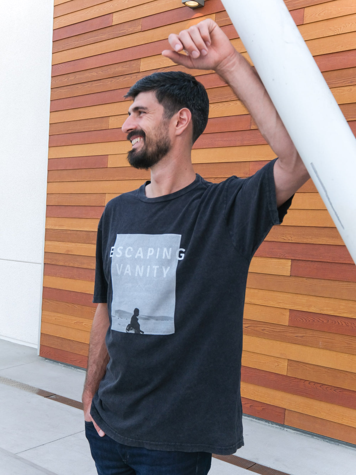 Christian Apparel - This "Band style Tee" is inspired by Ecclesiastes and the 'vanity of vanities' phrase repeated. We wanted to create a product that focuses on Escaping Vanity so we printed on this black washed tee those words along with a picture of a man walking in the dessert with his guitar.